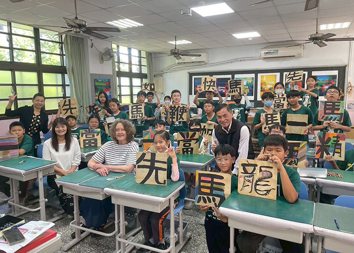 Art class posing for photograph with art