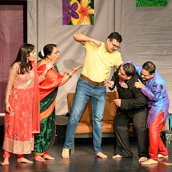 Posed scene from a stage production, with one man threatening to punch another