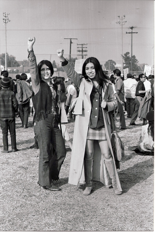 Protest Against Vietnam War / LA Moratorium (Two women at the LA Moratorium raising their right fists in solidarity)