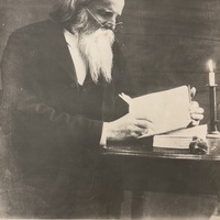 George S. Burleigh seated at a Desk and Working